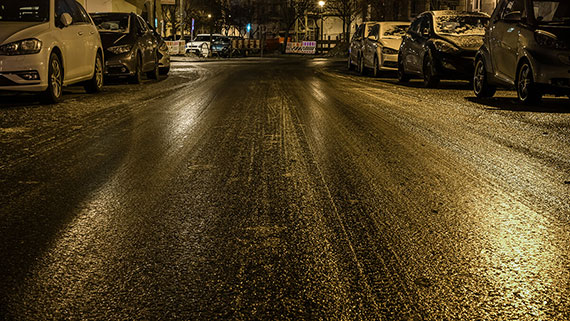 Colored lights reflecting off a slick icy road