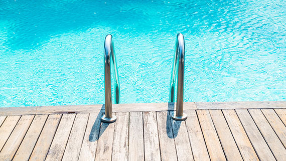 Children leaping together into pool