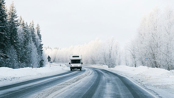 A motorhome parked at a snow covered campsite