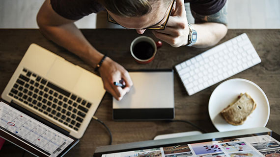 A businessman holding a small bulletin board with business buzzwords