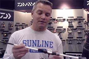 A man holding and inspecting a fishing rod