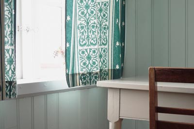 A close-up of a bedroom window and desk