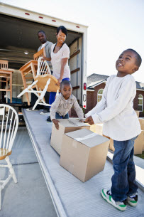 A family moving boxes out of a moving truck