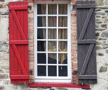 An outside view of window with scarve window treatments.